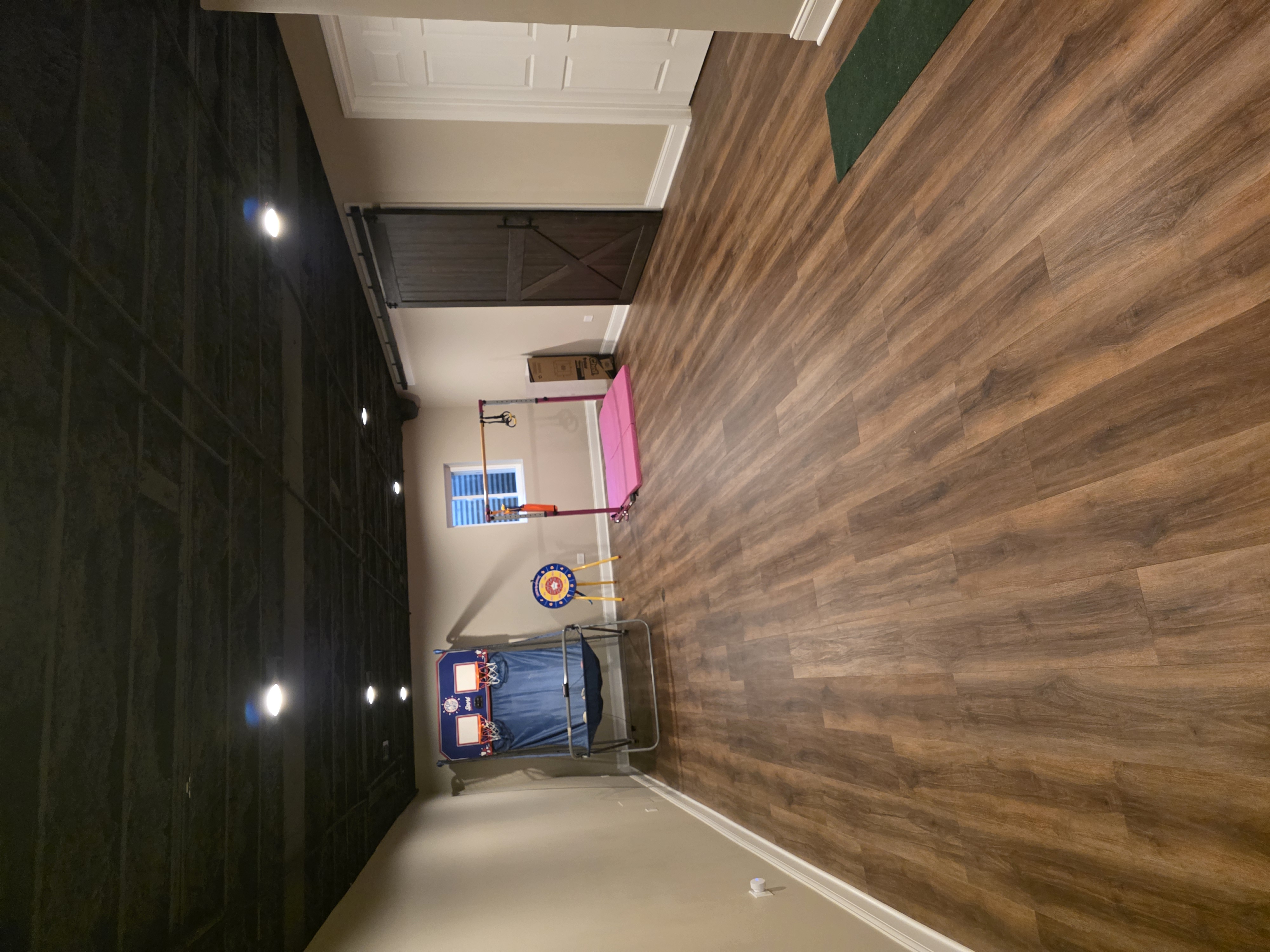 Open basement area with luxury vinyl plank flooring